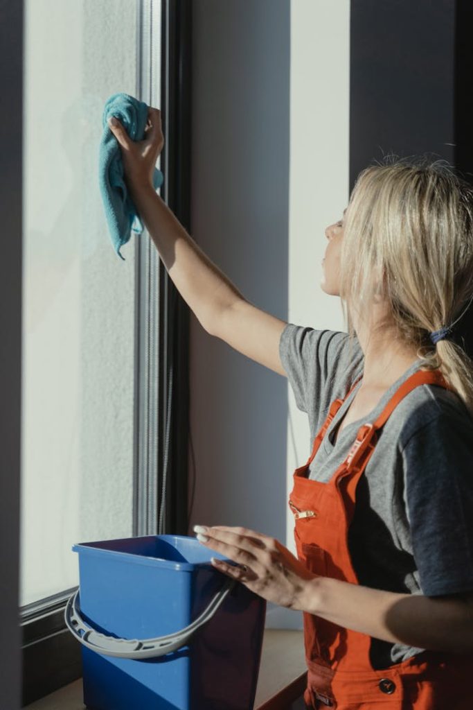 a woman cleaning a window | Residential Cleaning | used for luminexcleaning.